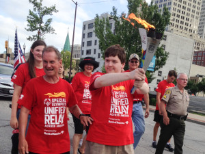 Matthew Thomas, brother of Nicolas Thomas, carries the torch for Special Olympics. Submitted photo